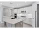 Bright kitchen with modern white cabinetry, stainless steel appliances, and a large island at 11717 Blue Hill Trl, Lakewood Ranch, FL 34211