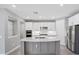 This modern kitchen has stainless steel appliances, a large island, and updated cabinetry at 11717 Blue Hill Trl, Lakewood Ranch, FL 34211