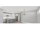 Gourmet kitchen with stainless steel appliances, white cabinetry, and gray island with bar seating at 11717 Blue Hill Trl, Lakewood Ranch, FL 34211