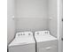 Bright laundry room featuring a wire rack shelf, white walls and brand new appliances at 11717 Blue Hill Trl, Lakewood Ranch, FL 34211