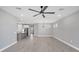 Open-concept living room features gray plank flooring, neutral walls, and ample natural light at 11717 Blue Hill Trl, Lakewood Ranch, FL 34211