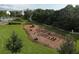 An aerial view of a playground with mature trees and green spaces offers a fun outdoor area for residents at 11717 Blue Hill Trl, Lakewood Ranch, FL 34211