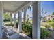 A welcoming porch showing white seating and views of the landscaping at 11717 Blue Hill Trl, Lakewood Ranch, FL 34211