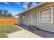 Exterior view of the home showcasing the door to the backyard and the home's neutral color at 1200 74Th N St, St Petersburg, FL 33710