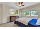 Bright bedroom features large windows, a ceiling fan, and dresser with drawers at 1200 74Th N St, St Petersburg, FL 33710