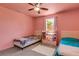 Pink bedroom with two beds and a storage shelf at 1200 74Th N St, St Petersburg, FL 33710