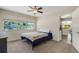 Comfortable bedroom with a ceiling fan, large windows offering a pleasant view at 1200 74Th N St, St Petersburg, FL 33710