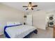 This bedroom includes carpeting, a ceiling fan, and closet for added storage at 1200 74Th N St, St Petersburg, FL 33710
