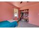 Pink bedroom with walk-in closet and window at 1200 74Th N St, St Petersburg, FL 33710