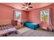 Colorful bedroom with two beds and a storage shelf at 1200 74Th N St, St Petersburg, FL 33710