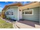 Inviting front entrance features a well-maintained lawn, updated landscaping, and a charming front door at 1200 74Th N St, St Petersburg, FL 33710