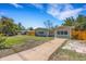 Charming home with a well-manicured lawn and a driveway at 1200 74Th N St, St Petersburg, FL 33710