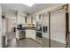 Bright kitchen featuring stainless steel appliances, white cabinetry, and tile flooring at 1200 74Th N St, St Petersburg, FL 33710