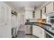 Charming kitchen with stainless steel appliances, white cabinets, and mosaic tile countertops at 1200 74Th N St, St Petersburg, FL 33710