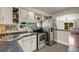 Updated kitchen with stainless steel appliances, open shelving and view to the living area at 1200 74Th N St, St Petersburg, FL 33710