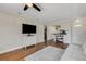 Cozy living room with hardwood floors and neutral paint with views into entryway and kitchen at 1200 74Th N St, St Petersburg, FL 33710