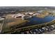Overhead view of neighborhood with a nearby school, sports fields, and surrounding lakes at 12307 Blue Hill Trl, Bradenton, FL 34211