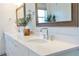 Bathroom featuring double sinks, white cabinets, quartz counters, and modern fixtures at 12307 Blue Hill Trl, Bradenton, FL 34211
