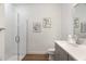 Bathroom featuring a modern tiled shower, a single sink vanity with grey cabinets and wood look tile floors at 12307 Blue Hill Trl, Bradenton, FL 34211