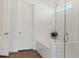 Bright bathroom with a soaking tub, glass enclosed shower, and white subway tile at 12307 Blue Hill Trl, Bradenton, FL 34211