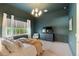 Bedroom with an accent colored wall, carpet flooring, with a large window at 12307 Blue Hill Trl, Bradenton, FL 34211