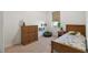 Bright bedroom boasts a wooden bed, a matching dresser, and a comfortable green beanbag at 12307 Blue Hill Trl, Bradenton, FL 34211