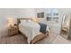 Bright bedroom with natural light, wood bed frame, and stylish decor at 12307 Blue Hill Trl, Bradenton, FL 34211