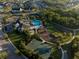Aerial shot of the community pool, playground, and sport court near lush trees at 12307 Blue Hill Trl, Bradenton, FL 34211