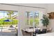 Light-filled dining area with a view of the screened pool and patio at 12307 Blue Hill Trl, Bradenton, FL 34211