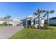 Well-maintained home with palm trees, a lush lawn, and charming curb appeal at 12307 Blue Hill Trl, Bradenton, FL 34211