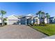 Charming single-story home boasts a two car garage, tropical plants, and landscaping at 12307 Blue Hill Trl, Bradenton, FL 34211