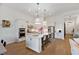 A spacious, bright kitchen with stainless appliances, island with seating, and wood flooring at 12307 Blue Hill Trl, Bradenton, FL 34211
