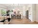 Open floorplan showcasing bright kitchen with white cabinets, island seating, and stainless appliances at 12307 Blue Hill Trl, Bradenton, FL 34211