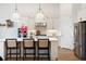Modern kitchen with island, stainless steel appliances, and pendant lighting above island at 12307 Blue Hill Trl, Bradenton, FL 34211