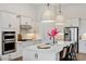 Bright and modern kitchen with a central island, stainless steel appliances, and contemporary lighting at 12307 Blue Hill Trl, Bradenton, FL 34211