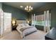 Stylish main bedroom suite with plush bed, lamps, and large window at 12307 Blue Hill Trl, Bradenton, FL 34211