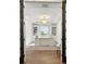 Bright home office with tray ceiling, chandelier, built in shelving, and large desk at 12307 Blue Hill Trl, Bradenton, FL 34211