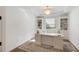 Bright home office with tray ceiling, built in shelving, and large desk at 12307 Blue Hill Trl, Bradenton, FL 34211