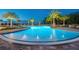 Inviting pool surrounded by palm trees, lounge chairs and lush landscaping at 12307 Blue Hill Trl, Bradenton, FL 34211