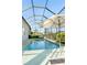 Outdoor pool area with a covered lanai, patio furniture, and a serene backyard view at 12307 Blue Hill Trl, Bradenton, FL 34211