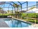 Beautiful pool with a screened-in enclosure plus a patio space for relaxing at 12307 Blue Hill Trl, Bradenton, FL 34211