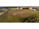 Scenic view of the school grounds with sports fields, tennis courts, and well-maintained landscaping at 12307 Blue Hill Trl, Bradenton, FL 34211