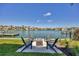 Inviting backyard seating around fire pit, with lovely waterfront views on a sunny day at 1333 Vista Dr, Sarasota, FL 34239