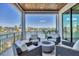 Relaxing balcony with waterfront views, comfortable seating, and a cozy fire pit at 1333 Vista Dr, Sarasota, FL 34239