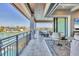 Covered balcony boasting water views and outdoor seating, ideal for entertaining or quiet relaxation by the water at 1333 Vista Dr, Sarasota, FL 34239