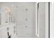 Elegant shower room featuring a rain shower, seamless glass door and marble wall tiling at 1333 Vista Dr, Sarasota, FL 34239
