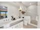 Elegant bathroom with dual sinks, marble accents, and a glass-enclosed shower at 1333 Vista Dr, Sarasota, FL 34239
