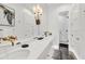 Modern bathroom with marble floors, gold fixtures, dual sinks, and a luxurious glass-enclosed shower at 1333 Vista Dr, Sarasota, FL 34239