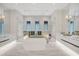 Spa-like bathroom with a freestanding tub, glass shower, and marble tile at 1333 Vista Dr, Sarasota, FL 34239