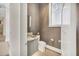 Powder room with patterned floors, a grey vanity, and a textured wall covering at 1333 Vista Dr, Sarasota, FL 34239